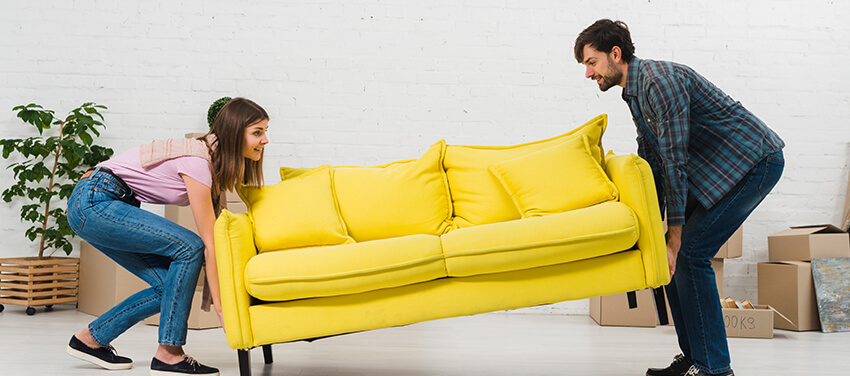 couple lifting a couch