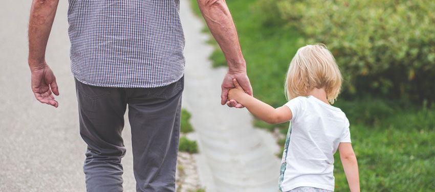 father holding his daughters hands