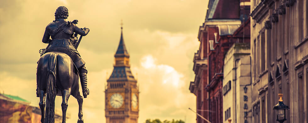 man riding horse infront of clocktower
