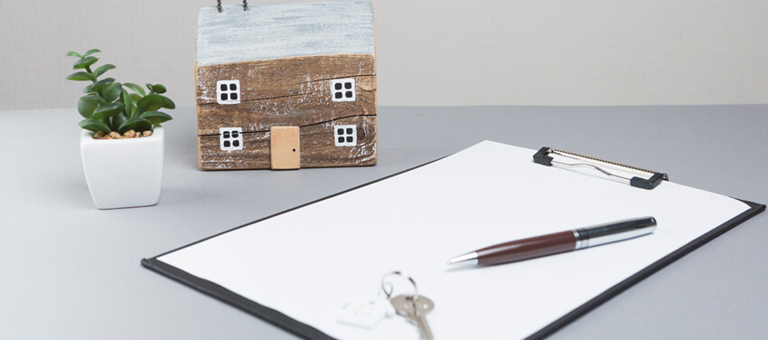 model house keys with clipboard grey surface