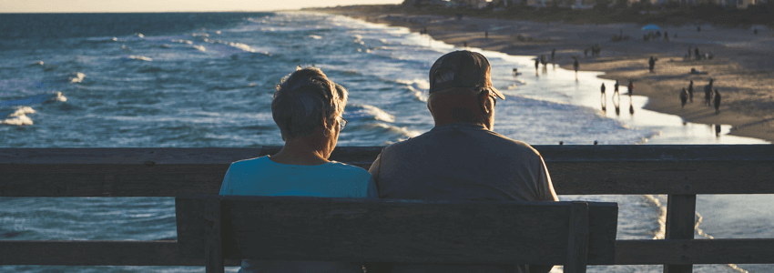 old people sitting in the beach